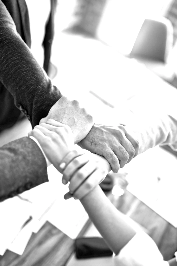team members gripping wrists in unity gesture