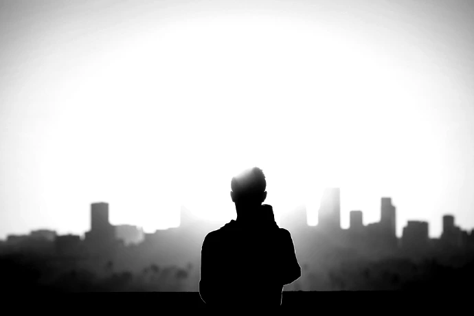 silhouette photography of standing person during sunset