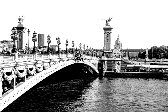 a bridge over a body of water with a statue on top